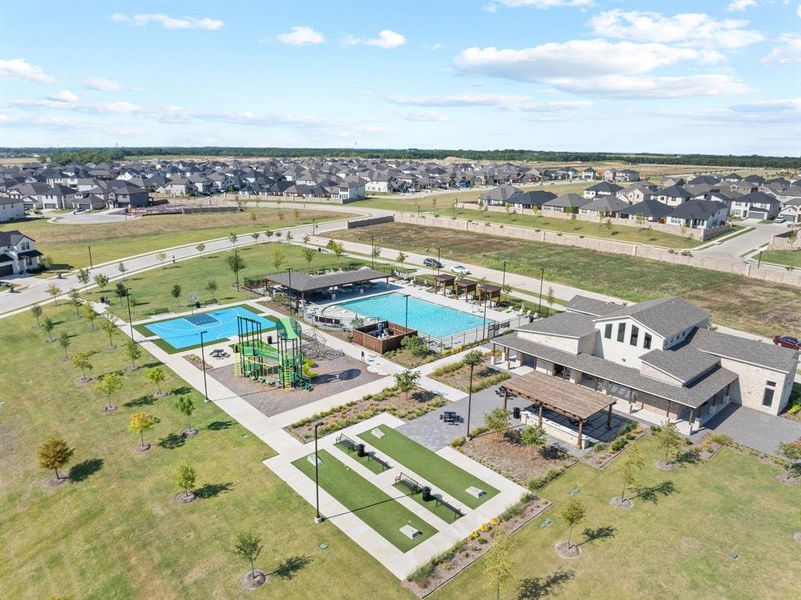 Aerial perspective of suburban area featuring a pool Aerial perspective of suburban area featuring a pool