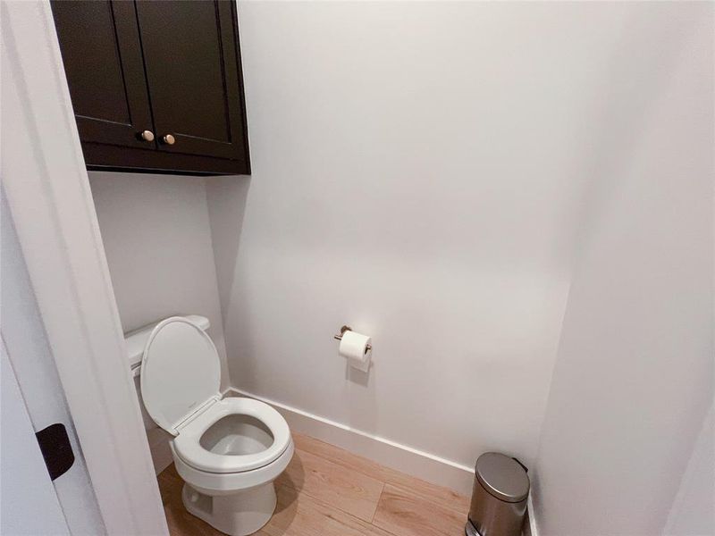 Bathroom featuring baseboards and light wood-style flooring