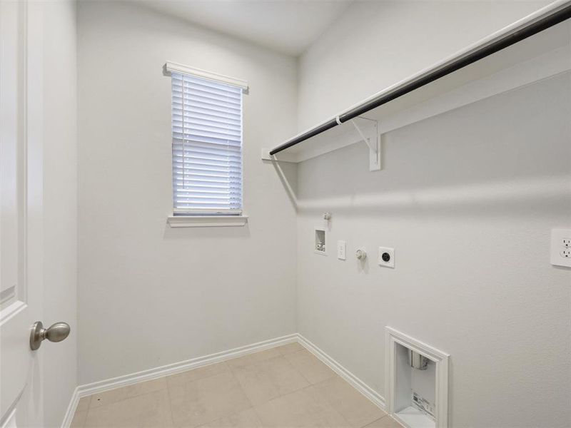 Washroom featuring hookup for a gas dryer, electric dryer hookup, baseboards, hookup for a washing machine, and laundry area Washroom featuring hookup for a gas dryer, electric dryer hookup, baseboards, hookup for a washing machine, and laundry area