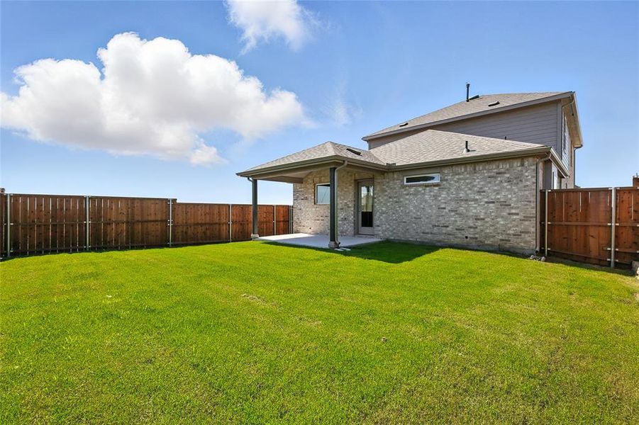 Back of property featuring a patio area, a fenced backyard, brick siding, and roof with shingles Back of property featuring a patio area, a fenced backyard, brick siding, and roof with shingles