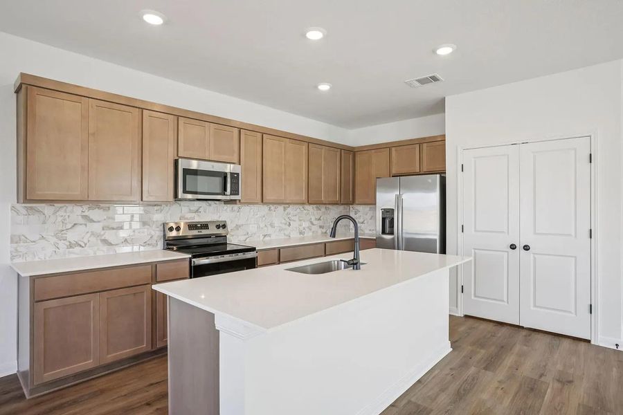 A well-appointed kitchen features a large island and stainless steel appliances, perfect for culinary endeavors. A well-appointed kitchen features a large island and stainless steel appliances, perfect for culinary endeavors.