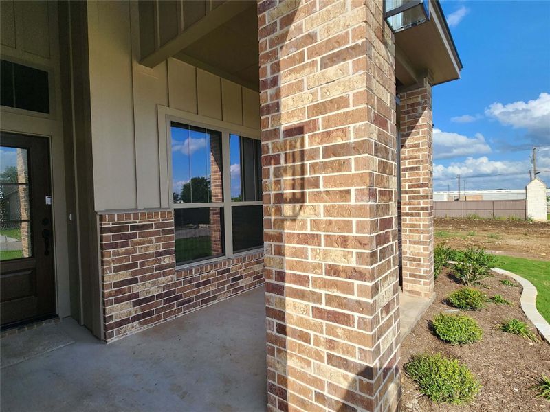 Entryway featuring brick and board-and-batten siding