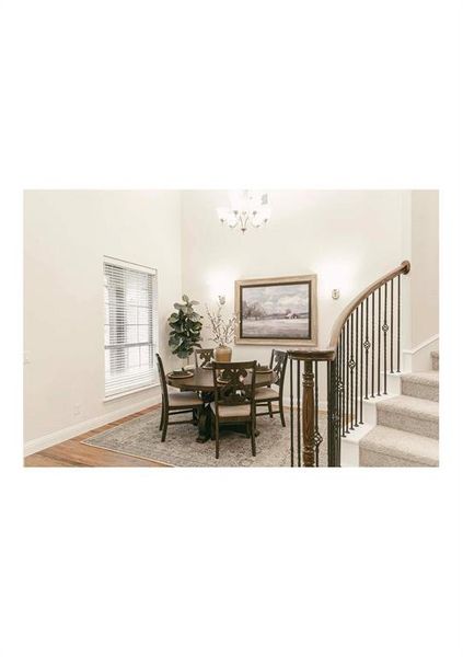 Dining room featuring an inviting chandelier and light hardwood / wood-style flooring