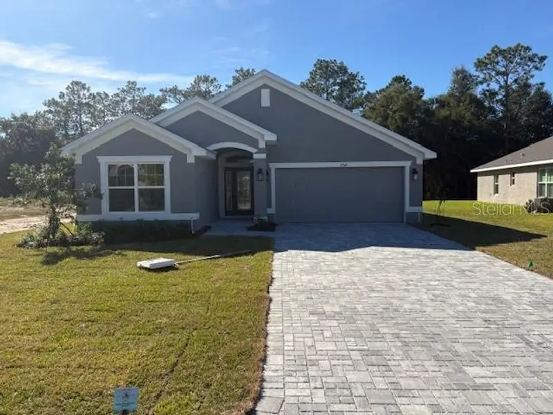 Front exterior of a new home in Juliette Falls, Dunnellon, FL, highlighting curb appeal (Image 2).