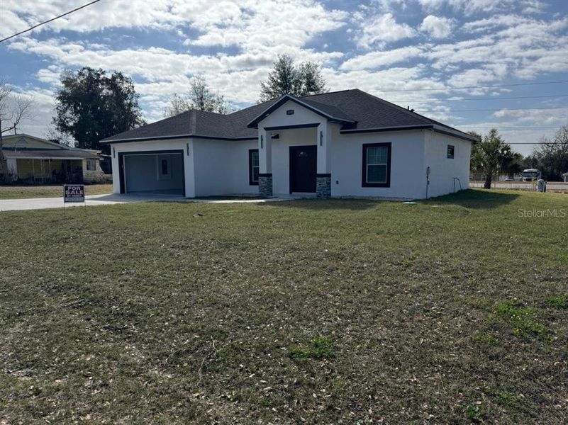 Front exterior of a new home in , Belleview, FL, highlighting curb appeal (Image 16).