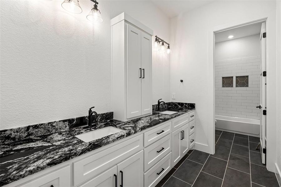 Full bathroom with tile patterned flooring, shower / tub combination, vanity, and toilet