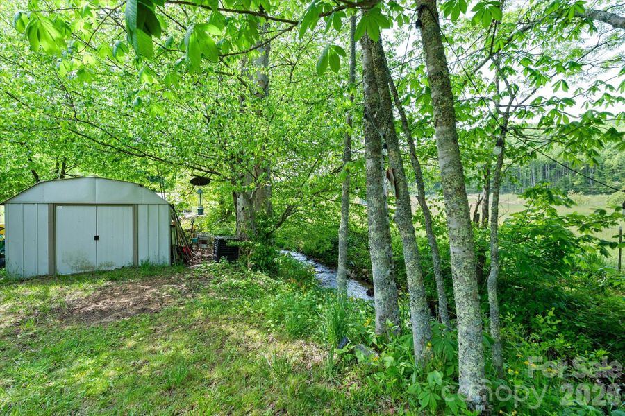 Shed along the creek conveys