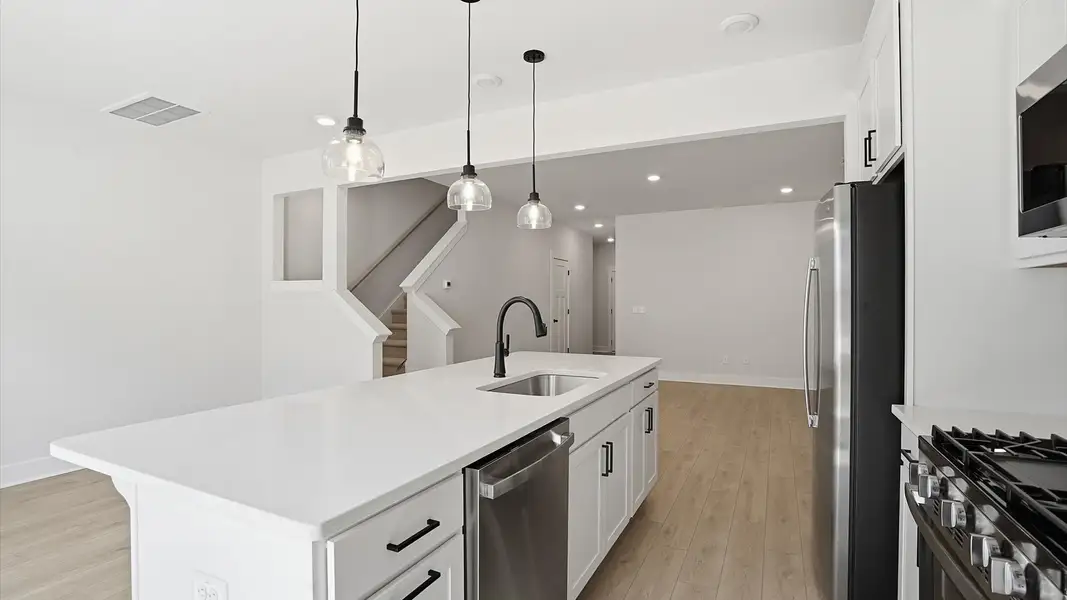 Memorable meals begin in this vibrant kitchen with pendant lighting and a thoughtfully designed island in Greenville, SC