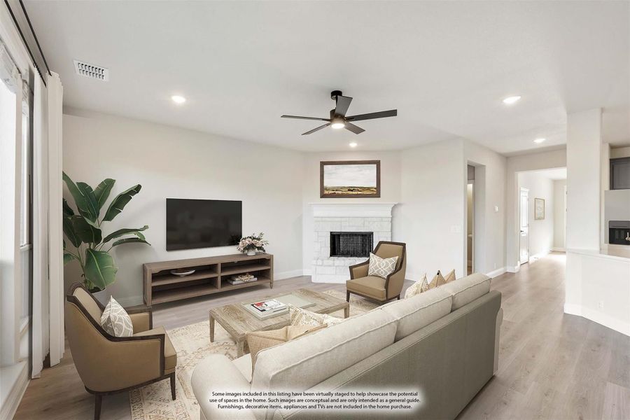 Open living room with white brick fireplace, ceiling fan, hardwood floors, and neutral furniture Open living room with white brick fireplace, ceiling fan, hardwood floors, and neutral furniture