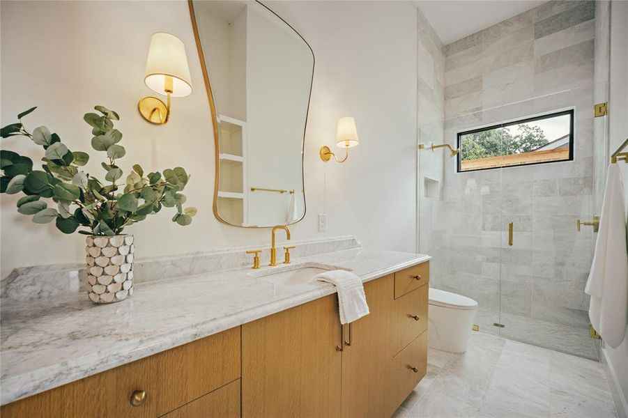 Full bathroom with vanity, a stall shower, and marble finish flooring
