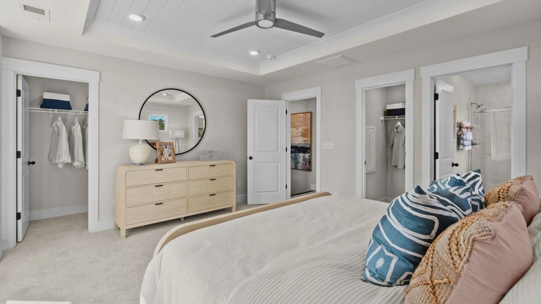 Primary suite with walk-in closet & en suite bathroom in a DRB Homes Brookgreen model home Primary suite with walk-in closet & en suite bathroom in a DRB Homes Brookgreen model home