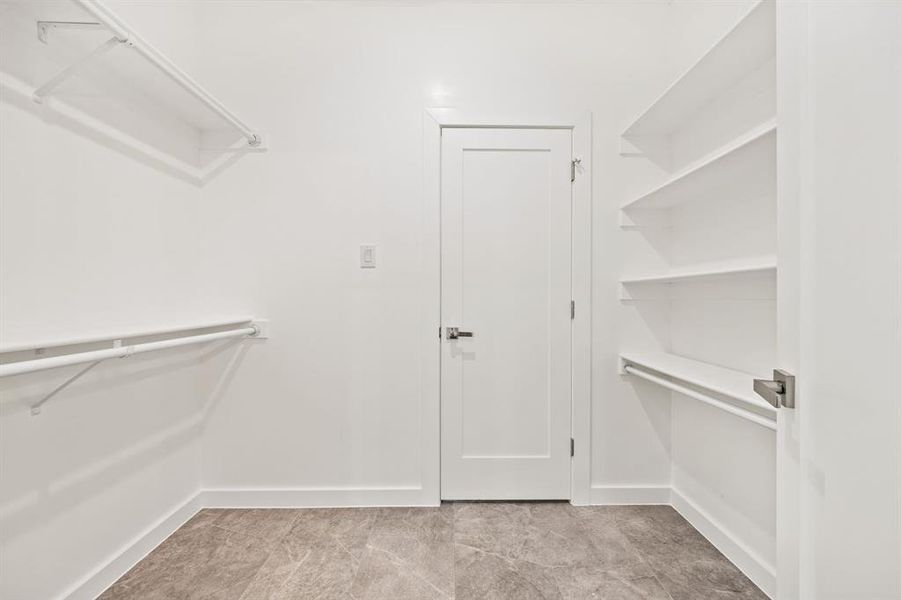 Walk in closet with light tile patterned floors