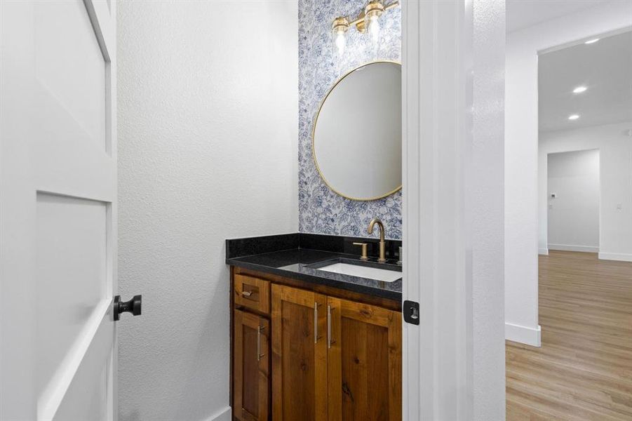 Bathroom featuring hardwood / wood-style flooring and vanity