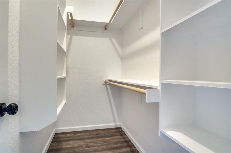 Walk in closet featuring dark hardwood / wood-style floors