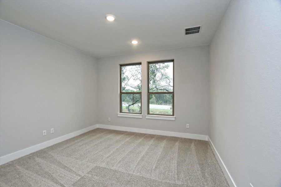Unfurnished room featuring recessed lighting, light carpet, baseboards, and visible vents