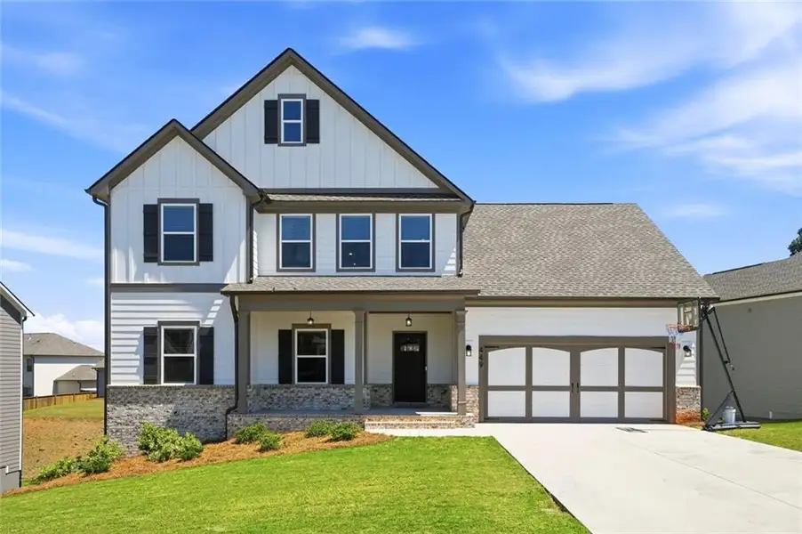 Front exterior of a new home in Calgary Downs, Winder, GA, highlighting curb appeal (Image 1). Front exterior of a new home in Calgary Downs, Winder, GA, highlighting curb appeal (Image 1).