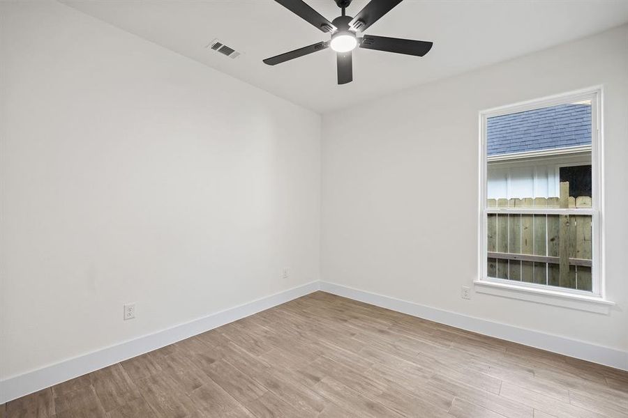 Unfurnished room with light wood-style flooring and baseboards