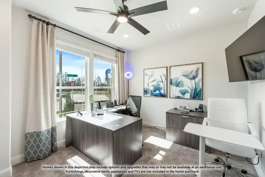 Home office with gray wood desk, ceiling fan, carpet floors, and large window with natural light Home office with gray wood desk, ceiling fan, carpet floors, and large window with natural light