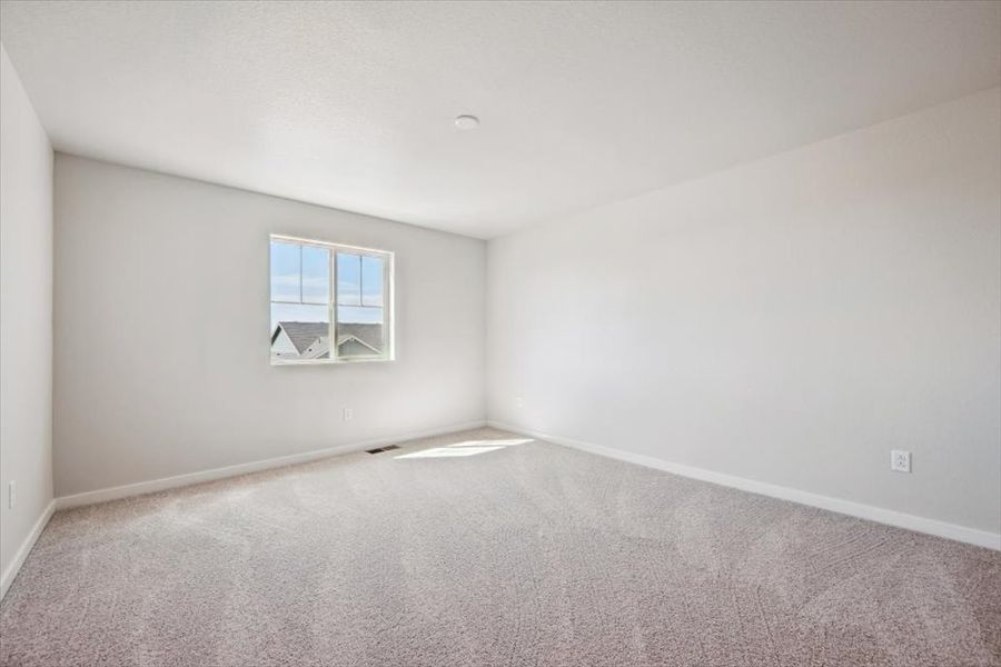 A room with a window and carpet. A room with a window and carpet.