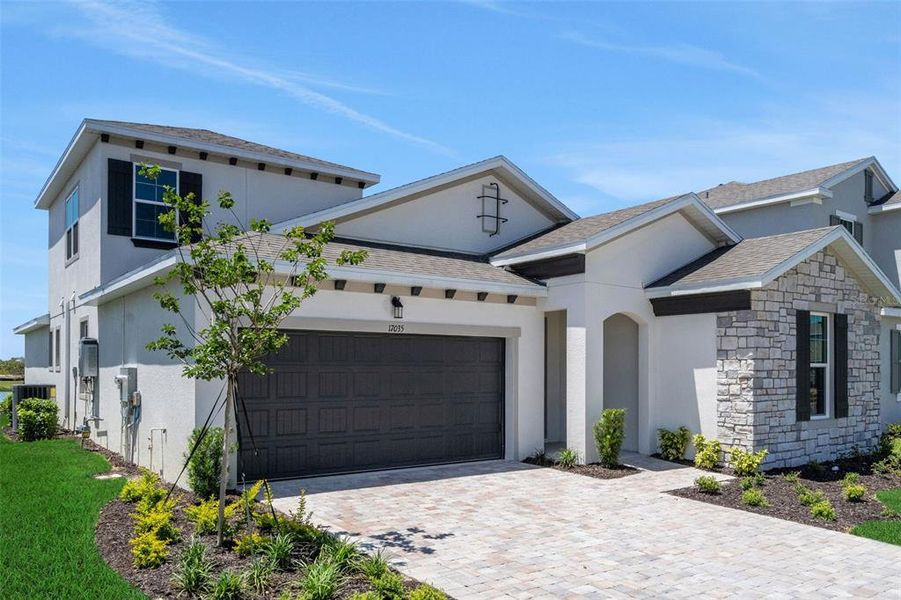 Front exterior of a new home in Creekside Run at Babcock Ranch, Punta Gorda, FL, highlighting curb appeal (Image 22).