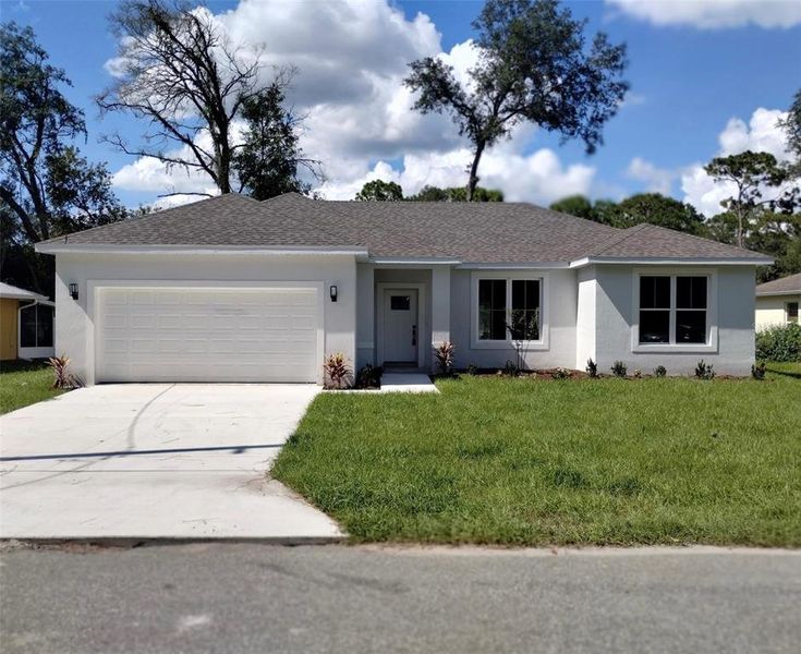 Front exterior of a new home in , Orange City, FL, highlighting curb appeal (Image 1). Front exterior of a new home in , Orange City, FL, highlighting curb appeal (Image 1).