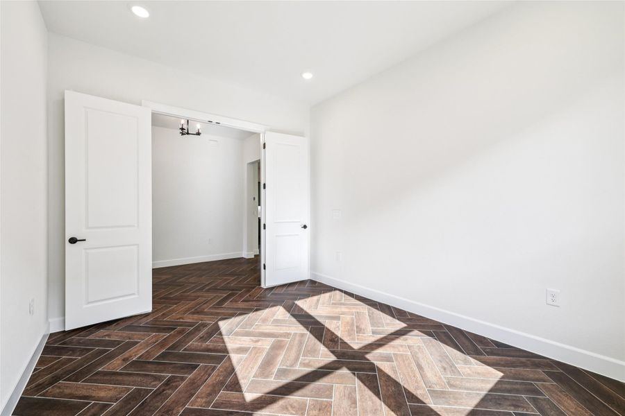 Spare room with baseboards and recessed lighting