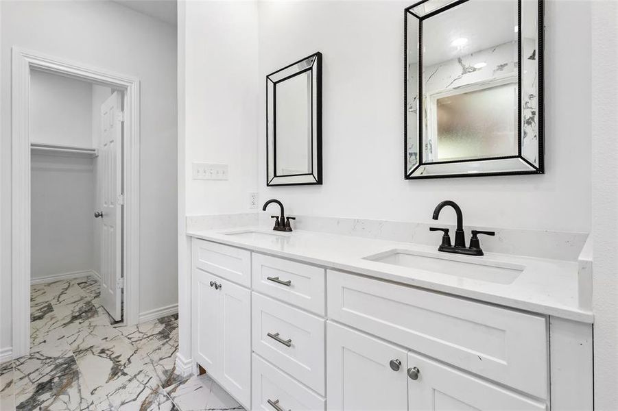 Master Bathroom, double vanities with beautiful marble pattern style floors in bath area and large walking in closet Master Bathroom, double vanities with beautiful marble pattern style floors in bath area and large walking in closet