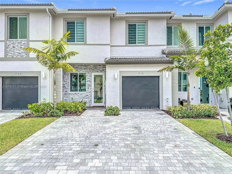 Front exterior of a new home in , Homestead, FL, highlighting curb appeal (Image 1). Front exterior of a new home in , Homestead, FL, highlighting curb appeal (Image 1).