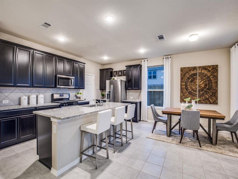 Bright kitchen with oversized island 
 *Photos of furnished model. Not actual home. Representative of floor plan. Some options and features may vary