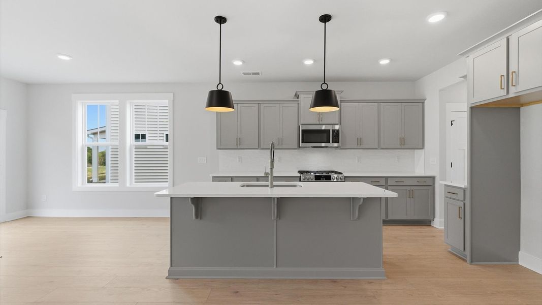 Tasteful design meets functional luxury in this kitchen with center island and modern pendant lighting at Foxbank