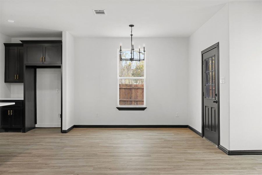 dining area featuring a notable chandelier and light wood-type flooring