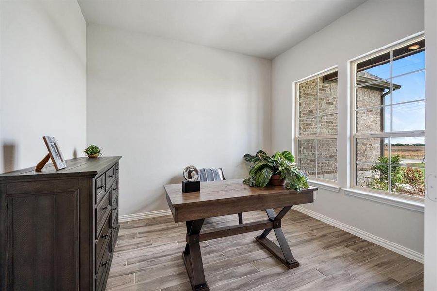 Office area with light wood finished floors and baseboards Office area with light wood finished floors and baseboards