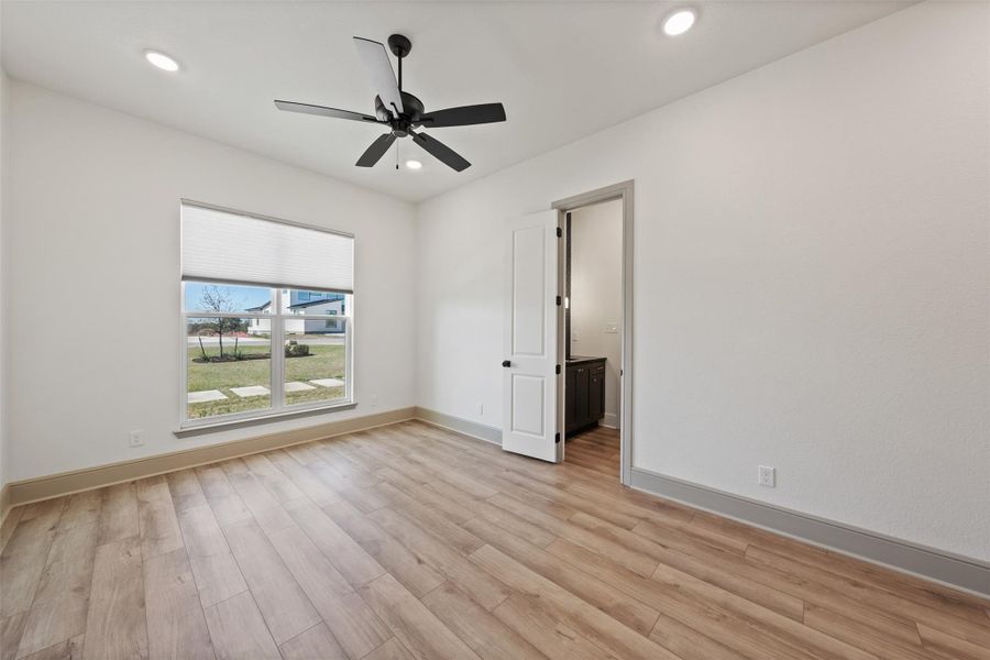 Empty room with a ceiling fan, recessed lighting, light wood-style floors, and baseboards