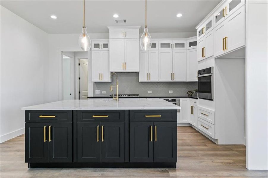 View of kitchen from living room showing ample kitchen island storage
