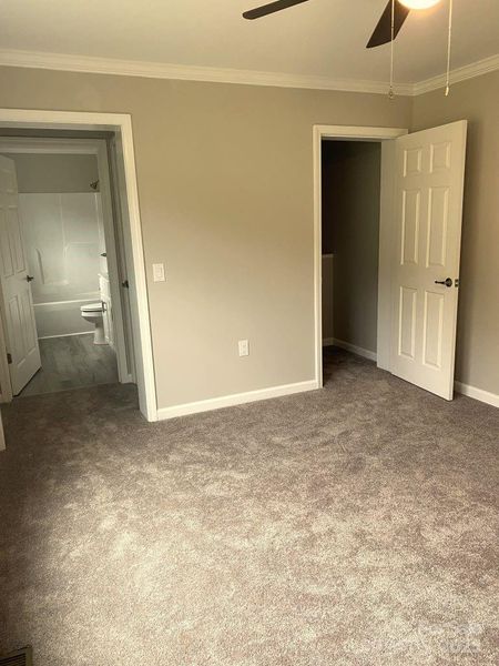 PRIMARY BEDROOM WALK-IN CLOSET ON RIGHT & BATHROOM ON LEFT