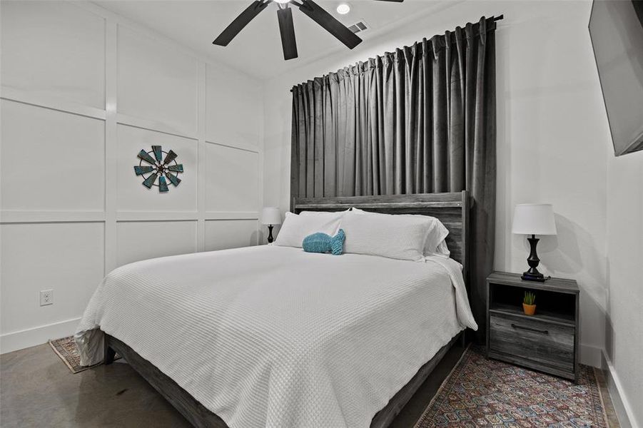 Bedroom with a decorative wall and ceiling fan