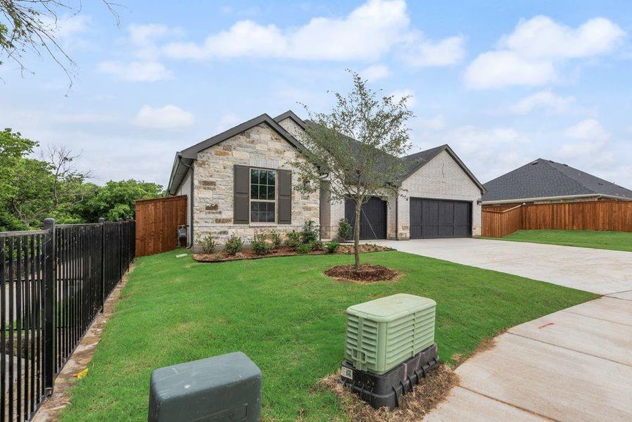 Front exterior of a new home in Valencia On The Lake, Little Elm, TX, highlighting curb appeal (Image 20).