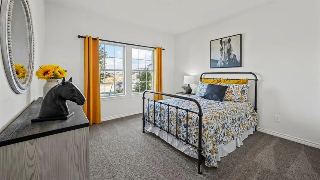 Bedroom featuring gray carpet, white walls, and a multi-pane window with white trim
