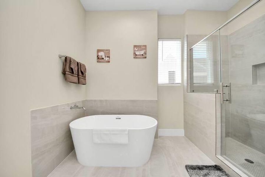 The primary bath gives you both options: a freestanding soaking tub when you want to unwind and a separate walk-in shower for the everyday routine.