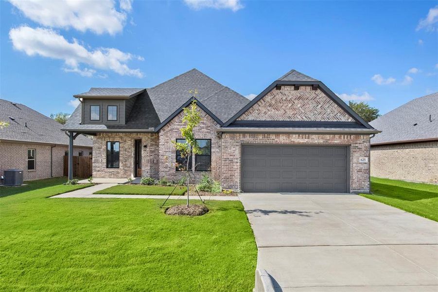 View of front of house featuring driveway, a garage, brick siding, roof with shingles, and a porch