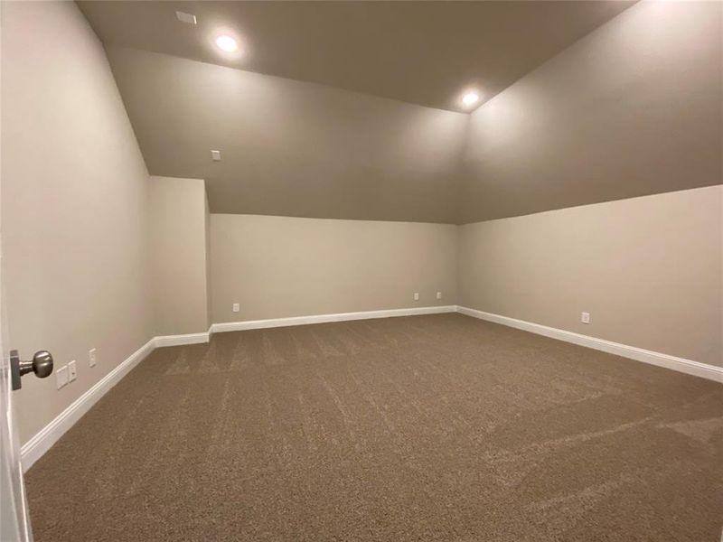 Large media room with no windows is perfect for watching movies or playing video games.