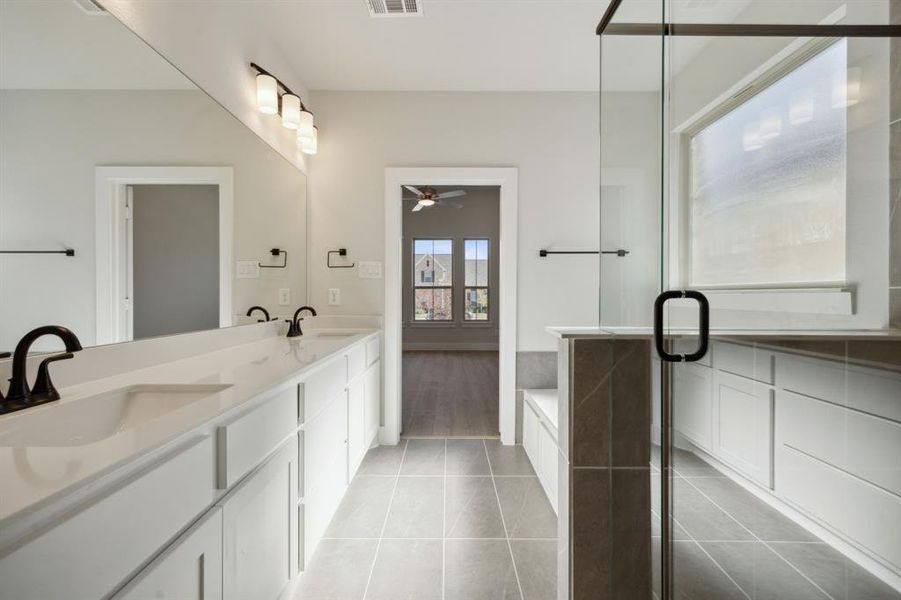 Bathroom featuring shower with separate bathtub, vanity, tile patterned floors, and ceiling fan