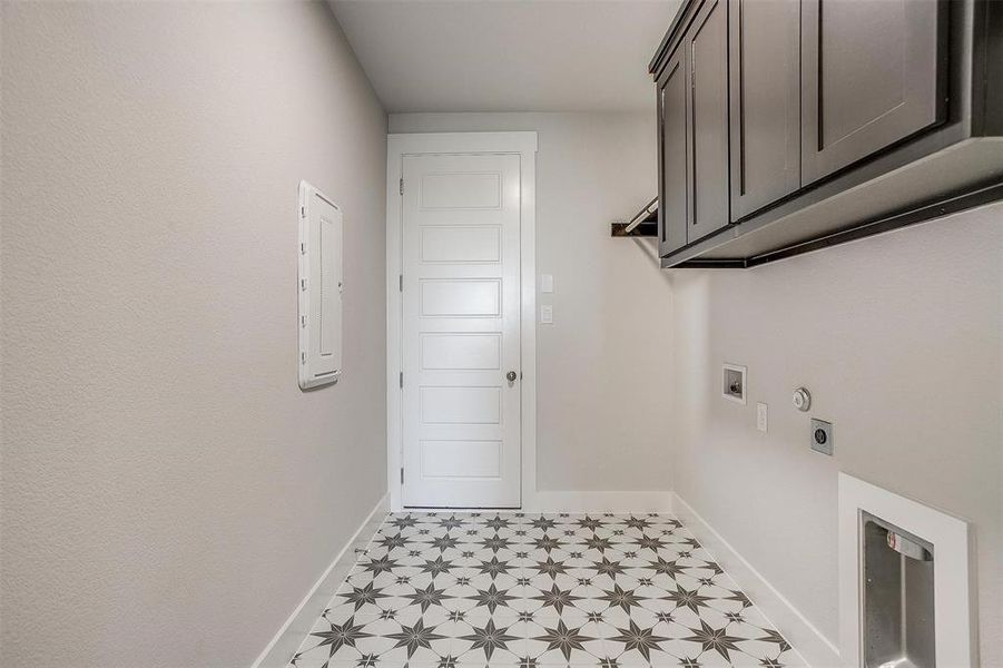 Laundry room with cabinets, light tile patterned floors, hookup for an electric dryer, and washer hookup