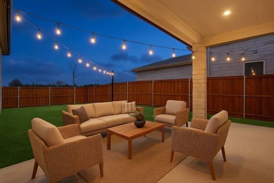 Patio at night featuring outdoor lounge area, a patio, and a fenced backyard virtually staged