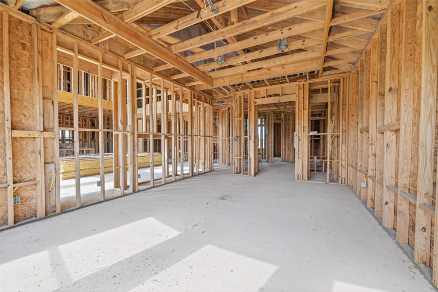 Open unfinished space showcasing framing and build progress.