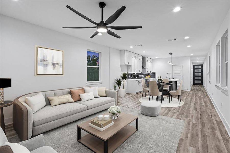 Living room featuring ceiling fan and light hardwood / wood-style floors