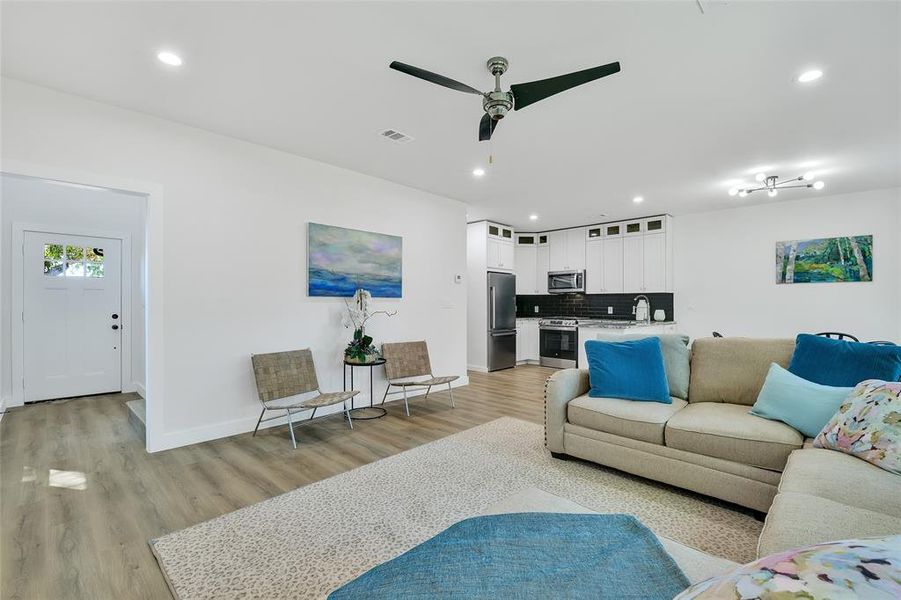 Living room featuring ceiling fan, light wood-type flooring