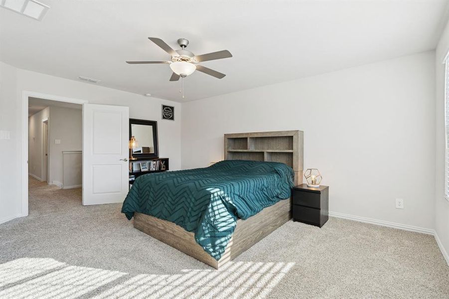 Bedroom featuring light colored carpet and ceiling fan