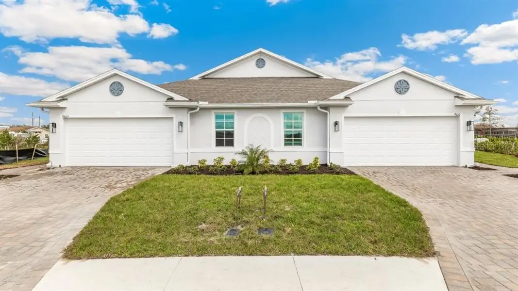Front exterior of a new home in Central Parc, North Port, FL, highlighting curb appeal (Image 1). Front exterior of a new home in Central Parc, North Port, FL, highlighting curb appeal (Image 1).