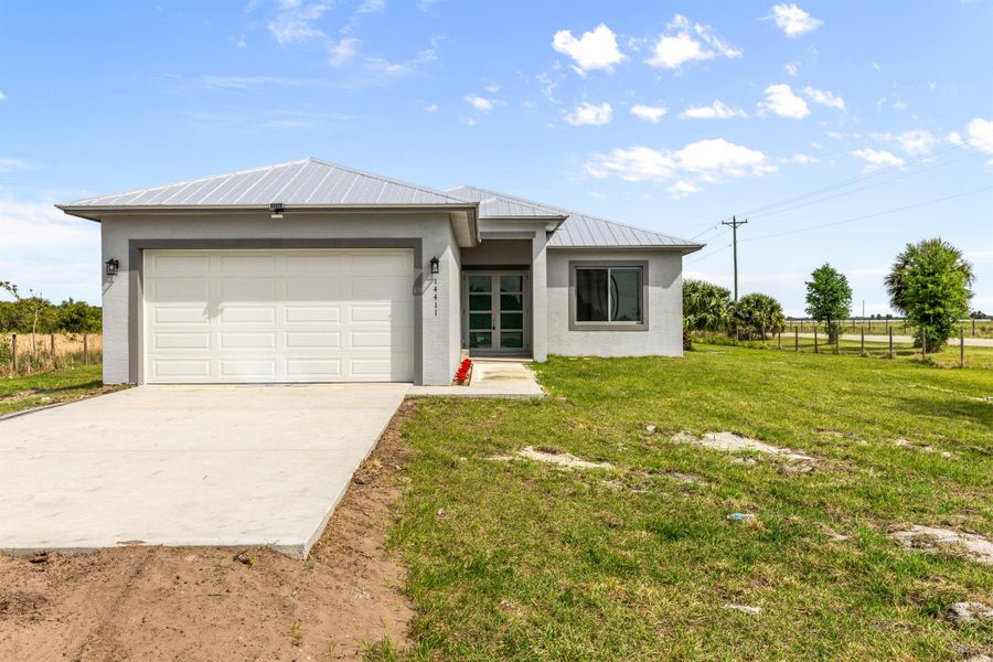Front exterior of a new home in , Okeechobee, FL, highlighting curb appeal (Image 1). Front exterior of a new home in , Okeechobee, FL, highlighting curb appeal (Image 1).